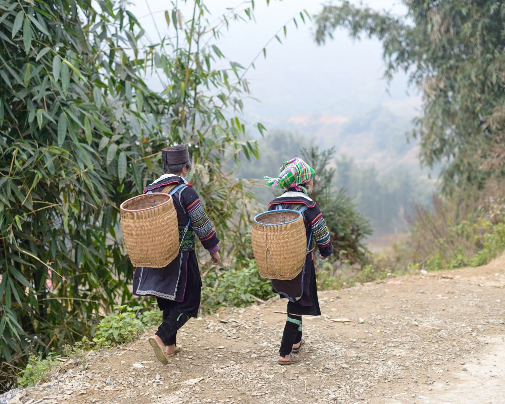 Two Dao girls walking on the mountain road